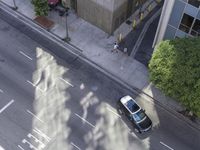 an overhead view shows the parking meters on a busy city street in a shadow - cast image