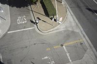 an overhead view shows the intersection at an intersection of two streets and two people crossing