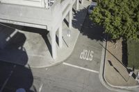 an overhead view shows the intersection at an intersection of two streets and two people crossing