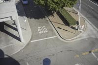 an overhead view shows the intersection at an intersection of two streets and two people crossing