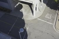 an overhead view shows the intersection at an intersection of two streets and two people crossing