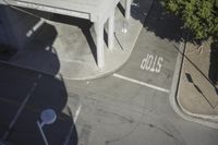 an overhead view shows the intersection at an intersection of two streets and two people crossing