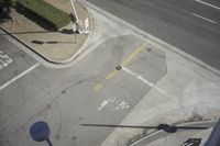 an overhead view shows the intersection at an intersection of two streets and two people crossing