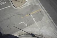 an overhead view shows the intersection at an intersection of two streets and two people crossing