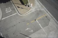 an overhead view shows the intersection at an intersection of two streets and two people crossing