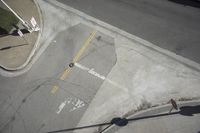 an overhead view shows the intersection at an intersection of two streets and two people crossing