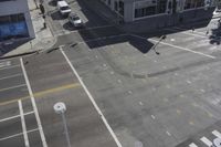 an overhead view shows the intersection at an intersection of two streets and two people crossing