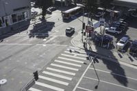 an overhead view shows the intersection at an intersection of two streets and two people crossing