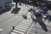 an overhead view shows the intersection at an intersection of two streets and two people crossing