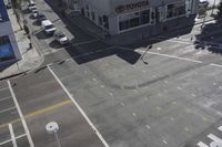 an overhead view shows the intersection at an intersection of two streets and two people crossing