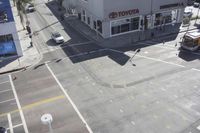 an overhead view shows the intersection at an intersection of two streets and two people crossing