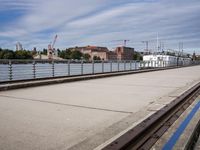 two paddleboats sit in the water near a bridge with a walkway that runs along it