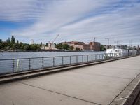 two paddleboats sit in the water near a bridge with a walkway that runs along it