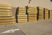 many pallets that are next to a building in the daytime time of the sun