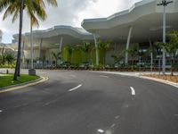 large modern building with large palm trees and other decorations on each corner of the entrance