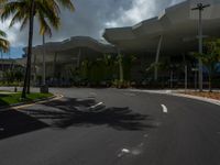 large modern building with large palm trees and other decorations on each corner of the entrance