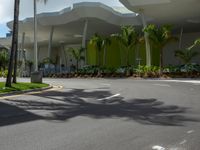 large modern building with large palm trees and other decorations on each corner of the entrance