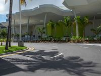 large modern building with large palm trees and other decorations on each corner of the entrance