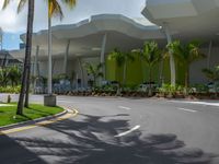 large modern building with large palm trees and other decorations on each corner of the entrance