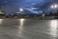 a view of new york city skyline at night from pier on the hudson river side