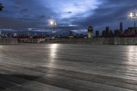 a view of new york city skyline at night from pier on the hudson river side