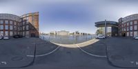 the 360 view panoramic image shows cars parked in a lot near a body of water