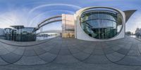 360 viewing panoramic view looking at building along river with bridge behind it and water in foreground