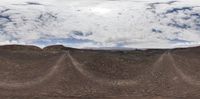 a panoramic view of clouds on the sky over the mountain tops in the desert