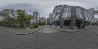 fisheye lens panoramic view of buildings in a city park area as the photographer zooms around them