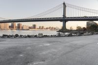 a city has been photographed in the foreground as the bridge spans into the distance