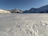 Panoramic View of Snow-covered Mountain Range with Clear Sky