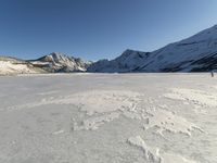 Panoramic View of Snow-covered Mountain Range with Clear Sky