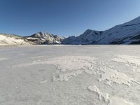 Panoramic View of Snow-covered Mountain Range with Clear Sky