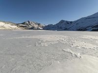 Panoramic View of Snow-covered Mountain Range with Clear Sky