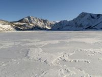 Panoramic View of Snow-covered Mountain Range with Clear Sky