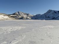 Panoramic View of Snow-covered Mountain Range with Clear Sky