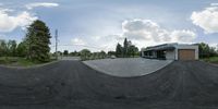 a panorama photo taken on the street with a bike path in the foreground and an empty building in the background