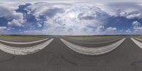 the view from a panoramic lens of the runway at the airport with large clouds in the blue sky above