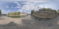 this picture shows the 360 eye view of a street, river and buildings in paris