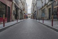 an empty street is pictured next to tall buildings in paris, france on march 3