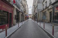 an empty street is pictured next to tall buildings in paris, france on march 3