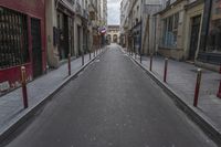 an empty street is pictured next to tall buildings in paris, france on march 3