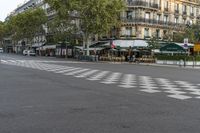 there is a street with checkered traffic at this time of day, and trees all over the street