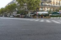 there is a street with checkered traffic at this time of day, and trees all over the street