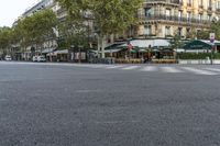 there is a street with checkered traffic at this time of day, and trees all over the street