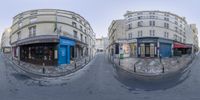 a fisheye image of two buildings and a street that is empty with no cars