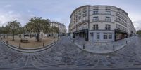 the picture shows the street and buildings in an image using 360 - view lenses