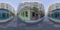 the camera panoramic picture shows the different levels of a street with shops and buildings