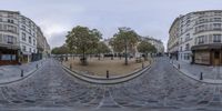 a very long wide angle fisheye lens is shown on a circular road corner in paris