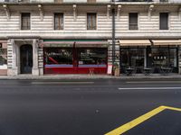 this is an outside restaurant that is on the corner of a street in paris with the entrance and windows open